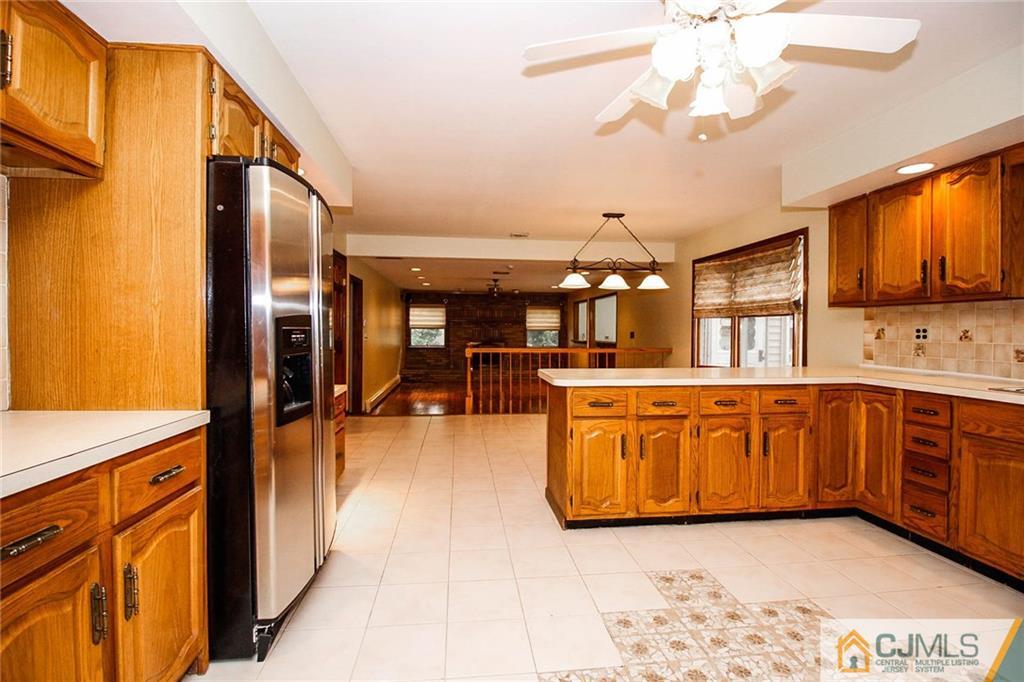 53 Hillsdale Road Edison, NJ 08820 - Photo 7 of 25 a view of kitchen with stainless steel appliances granite countertop a sink dishwasher stove top oven with cabinets and wooden floor