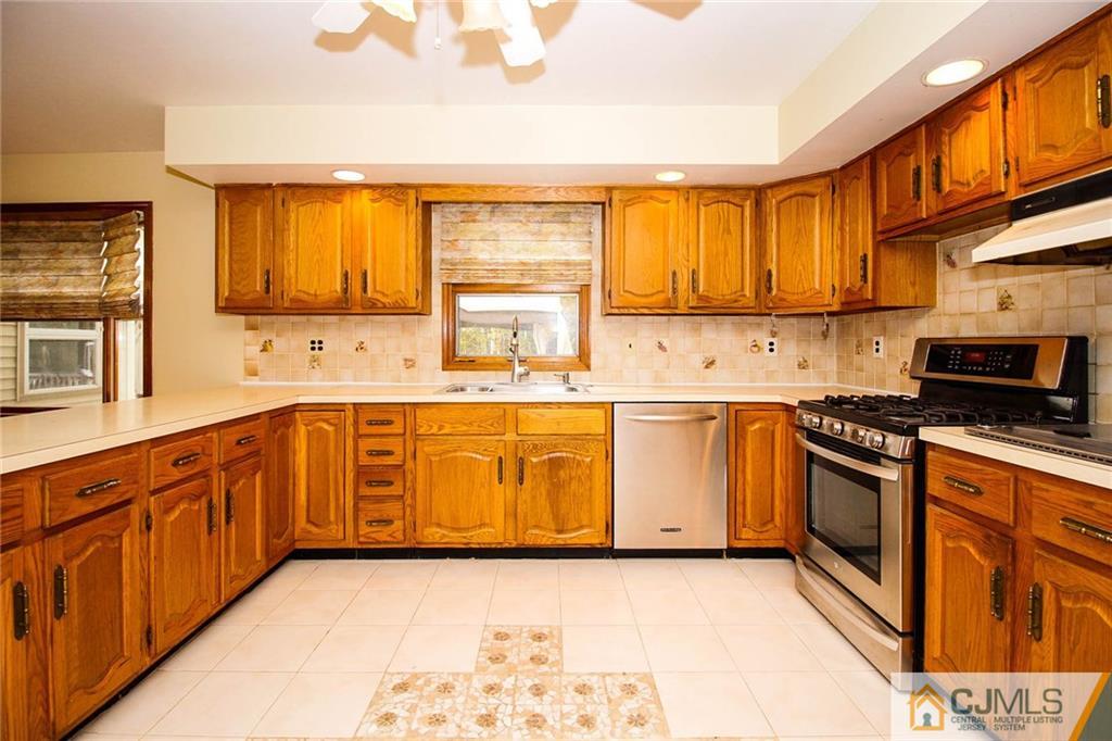 53 Hillsdale Road Edison, NJ 08820 - Photo 8 of 25 a kitchen with stainless steel appliances granite countertop a stove a sink and a microwave