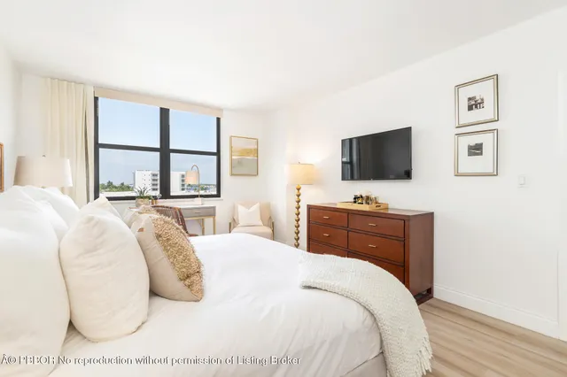 a bathroom with a granite countertop sink a toilet and a mirror