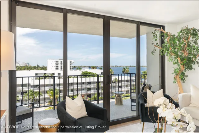 a living room with furniture and a floor to ceiling window
