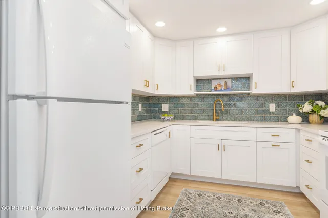 a bedroom with a bed and a dresser with large mirror