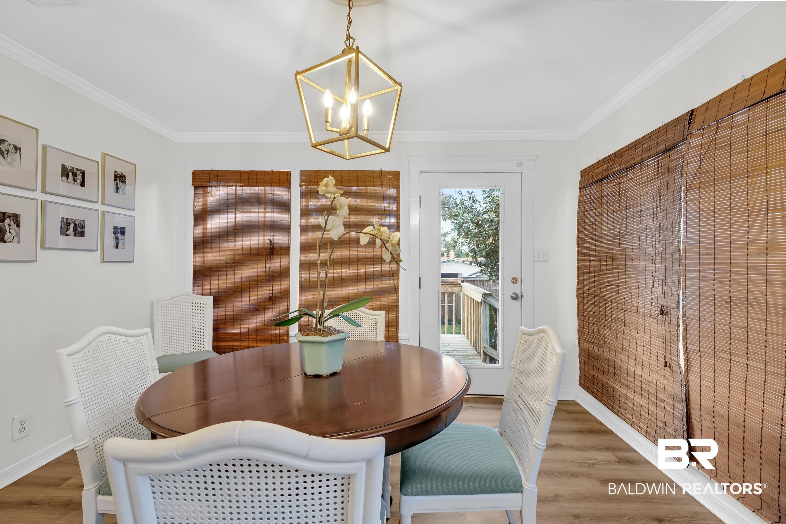 18 York Place Mobile, AL 36608 - Photo 11 of 27 Dining area featuring wood finished floors, crown molding, and a chandelier