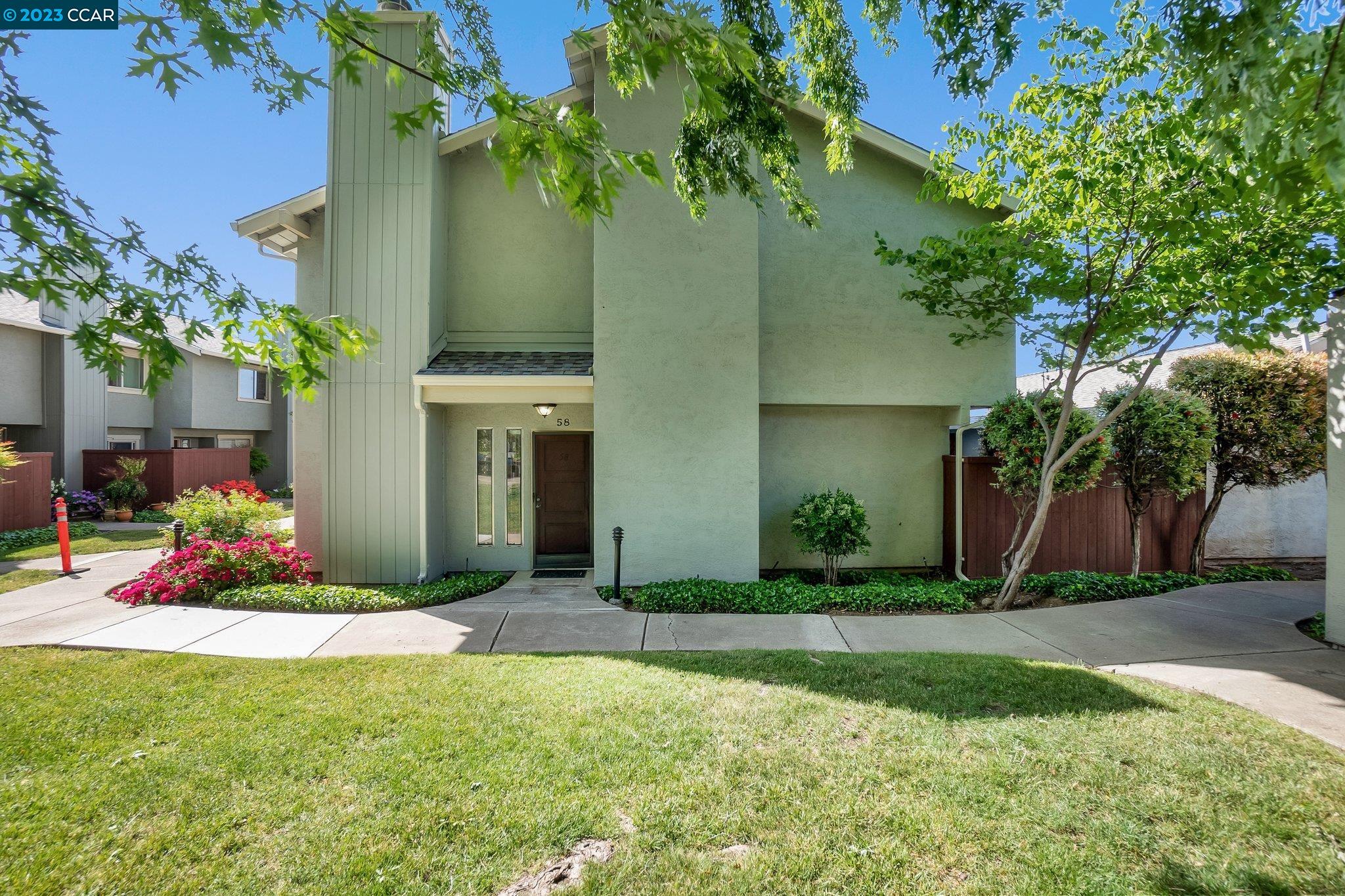 a front view of a house with a yard