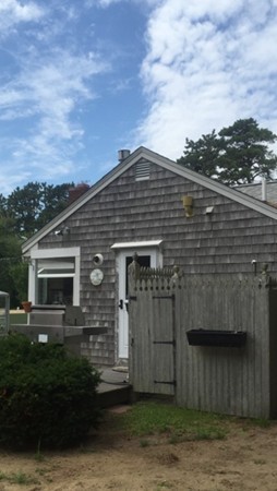 10 Glendon Road Dennis, MA 02639 - Photo 3 of 10 a front view of a house with a garden