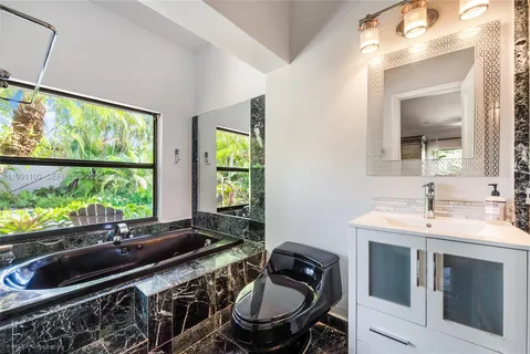 a kitchen with a stove a sink and a window
