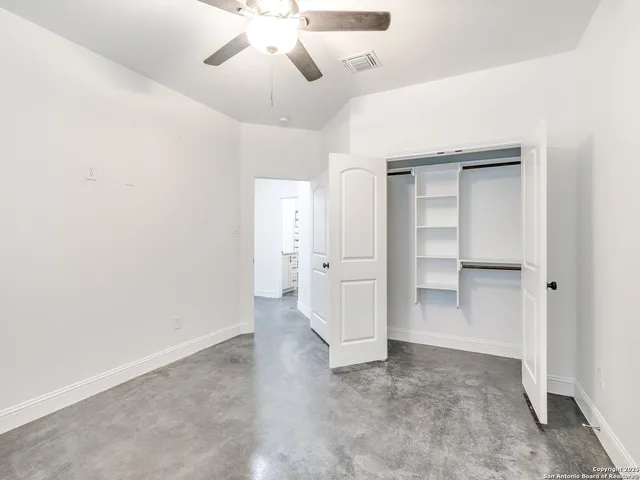 a bathroom with a granite countertop bathtub shower sink vanity and toilet