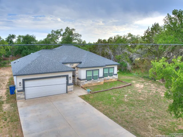 a aerial view of a house with a yard