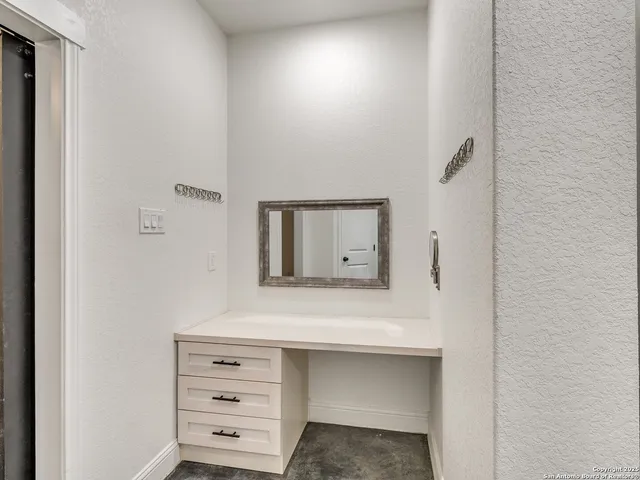 a bathroom with a granite countertop sink and a mirror