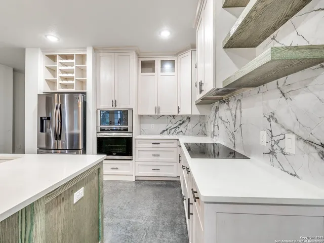 a kitchen with stainless steel appliances cabinets a sink and a stove