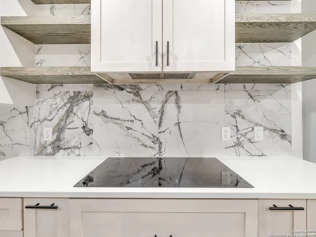 a view of a kitchen with a sink and dishwasher with wooden floor