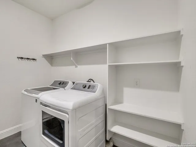 an empty room with cabinet and mirrors