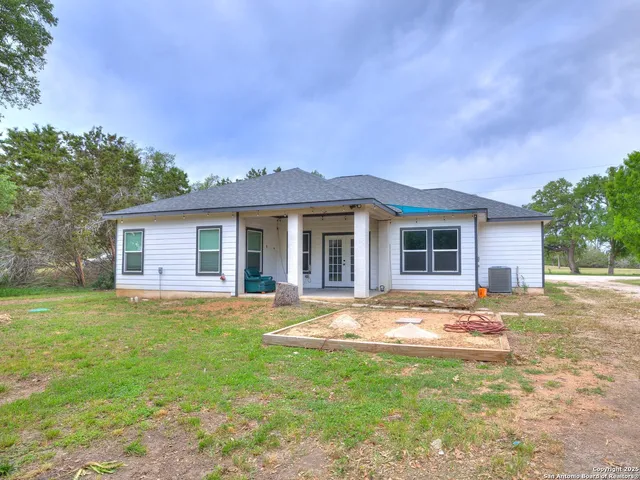 a front view of a house with a garden and patio