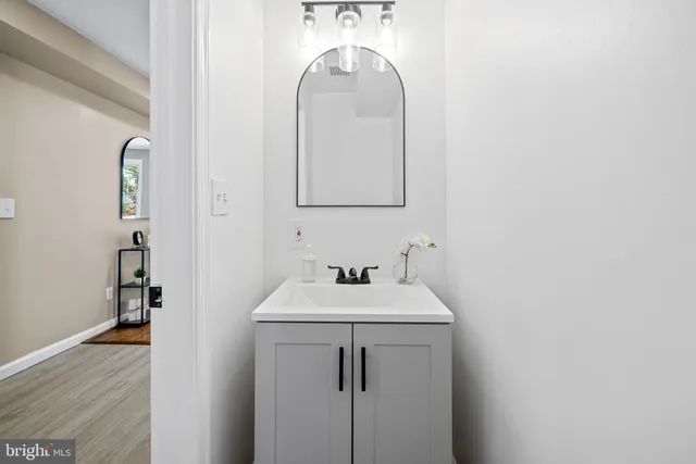 a bathroom with a sink a mirror and vanity
