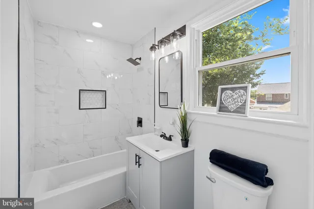 a bathroom with a bathtub sink and mirror