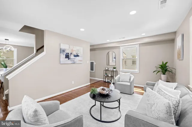 a living room with furniture or couch and a potted plant