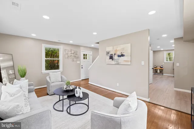 a living room with furniture windows and a table