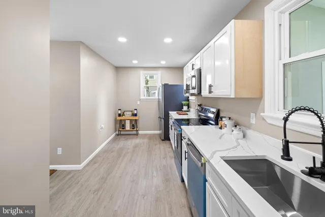 a view of a kitchen with a sink and cabinets