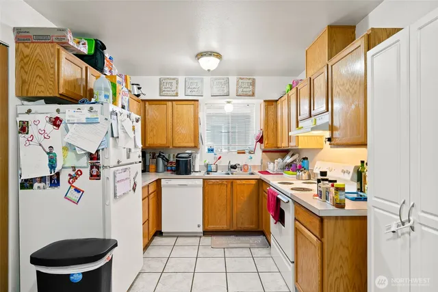 a kitchen with a sink appliances and cabinets