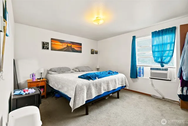 a bedroom with a bed and a couch