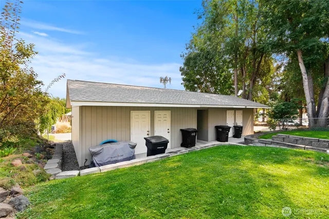 a view of a house with a yard and sitting area