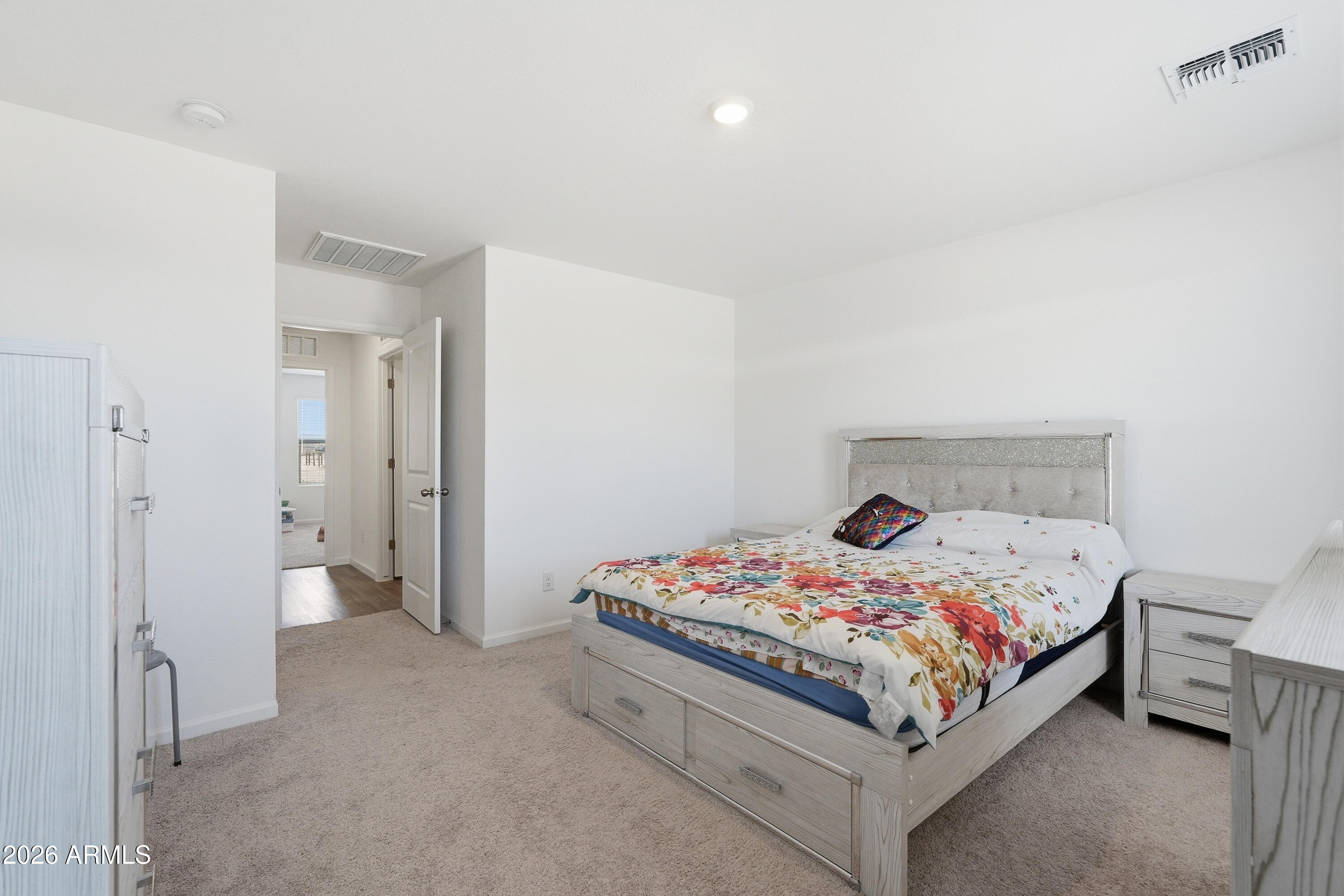 15610 South Moon Valley Road Arizona City, AZ 85123 - Photo 20 of 36 a bed sitting in a bedroom next to a bathroom