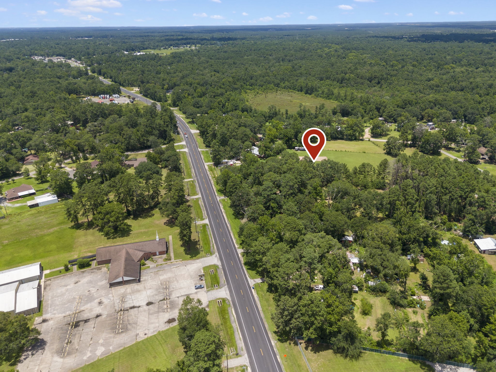 15091 Farm To Market 1485 Conroe, TX 77306 - Photo 2 of 11 a view of a city with lush green forest