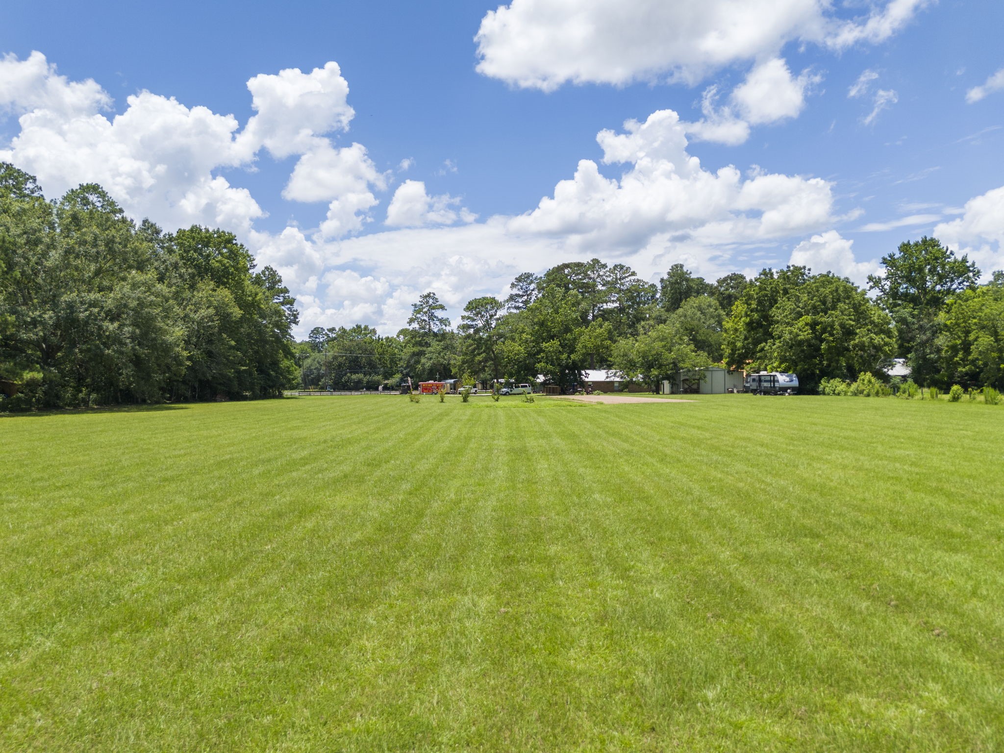 15091 Farm To Market 1485 Conroe, TX 77306 - Photo 4 of 11 a view of building with garden and trees in the background