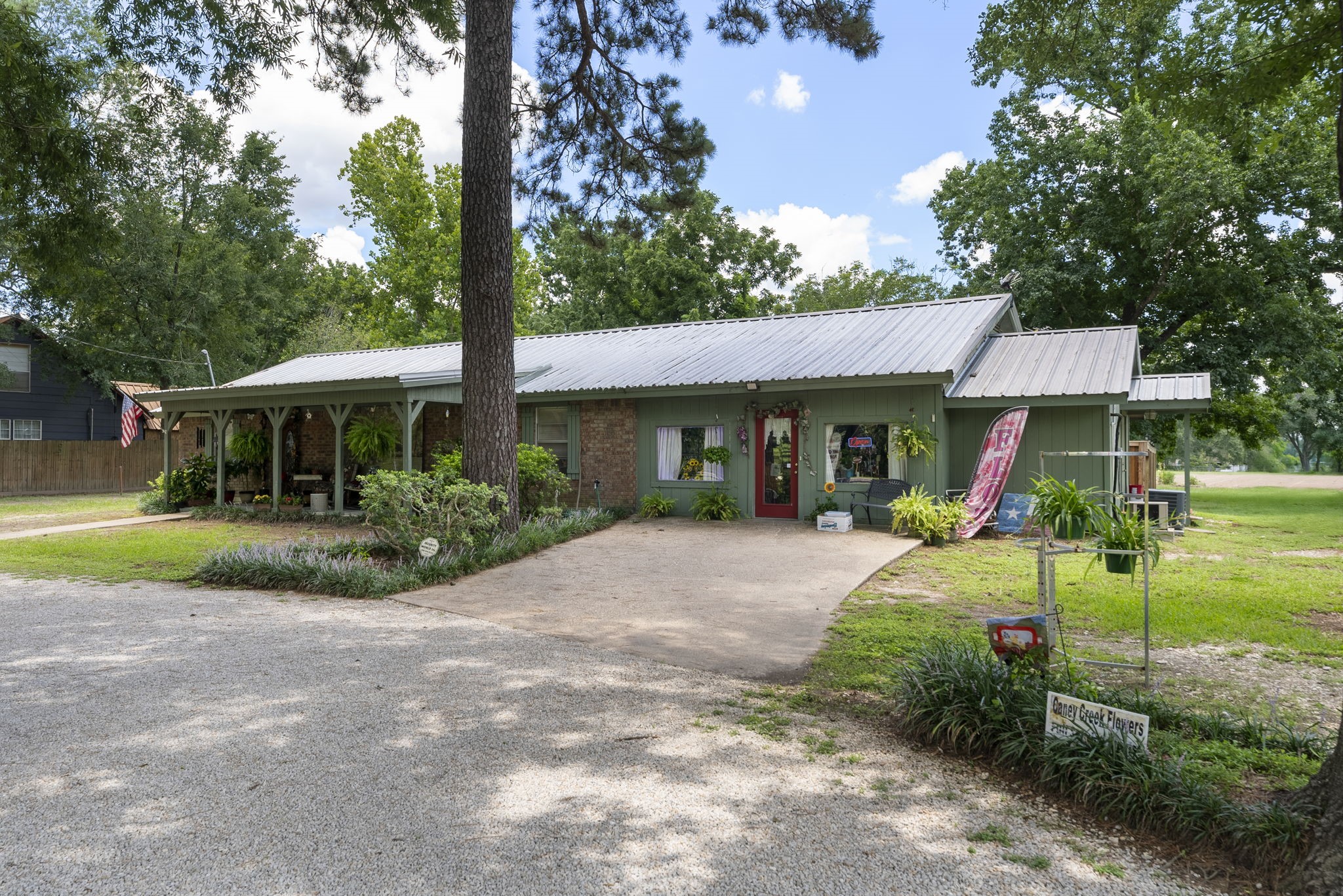 15091 Farm To Market 1485 Conroe, TX 77306 - Photo 5 of 11 a view of a house with a yard and potted plants