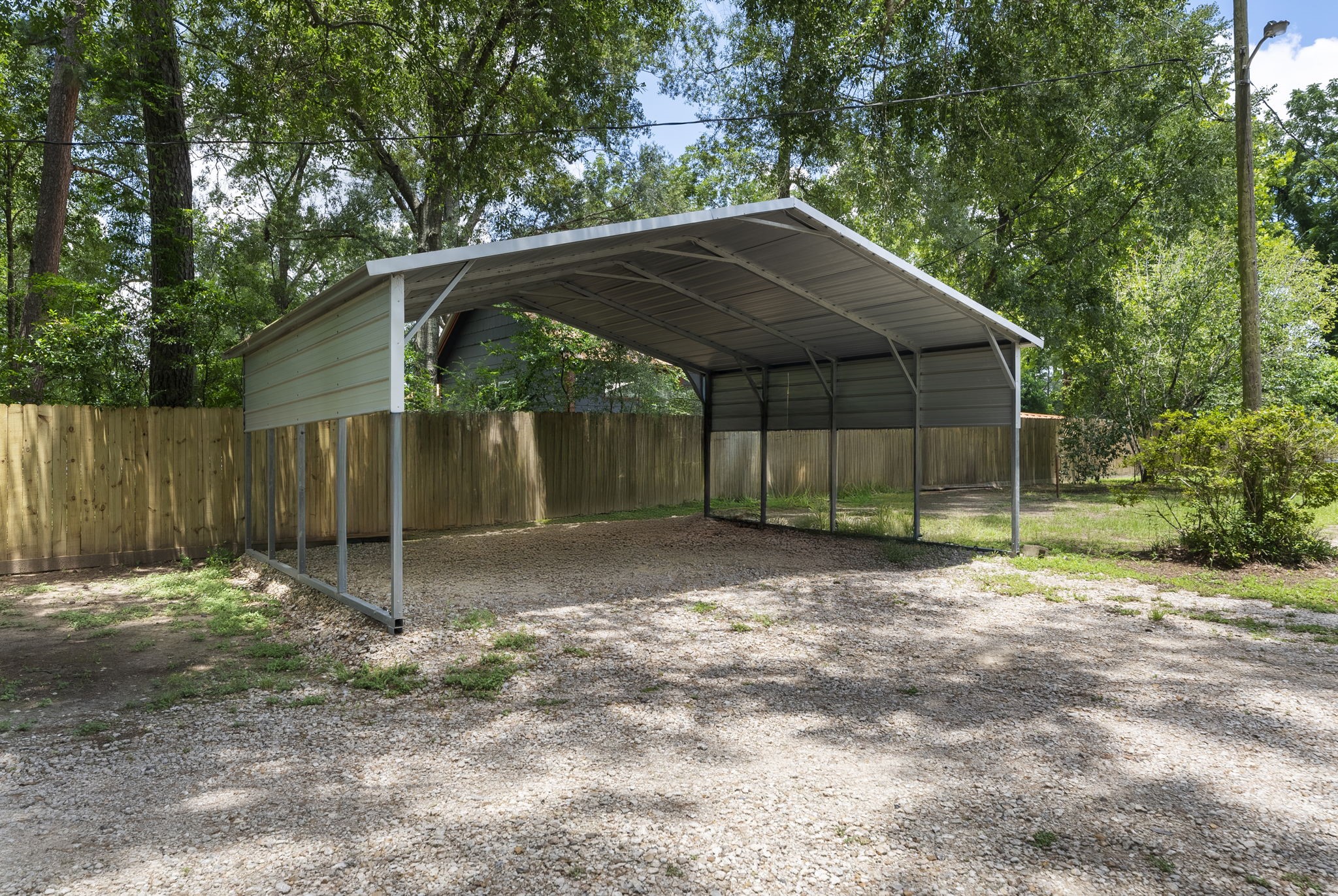15091 Farm To Market 1485 Conroe, TX 77306 - Photo 7 of 11 a backyard of a house with a small barn