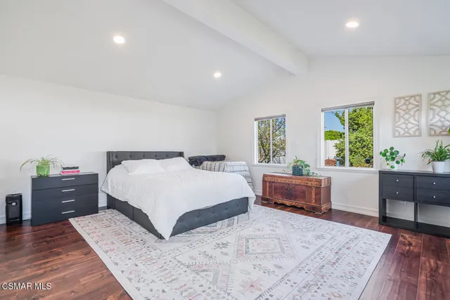 a bedroom with a large bed and a couch