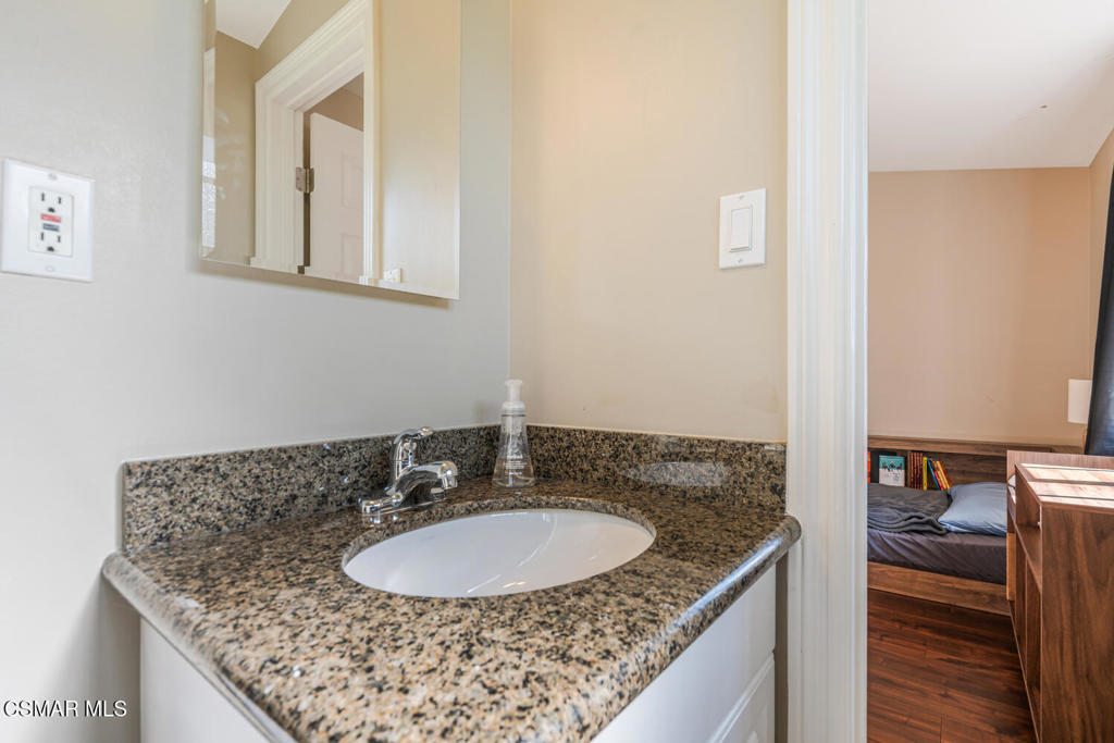 807 Briarcliff Road Thousand Oaks, CA 91360 - Photo 18 of 28 a bathroom with a granite countertop sink and a mirror