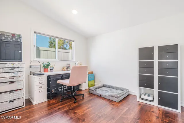 a living room with furniture and a book shelf