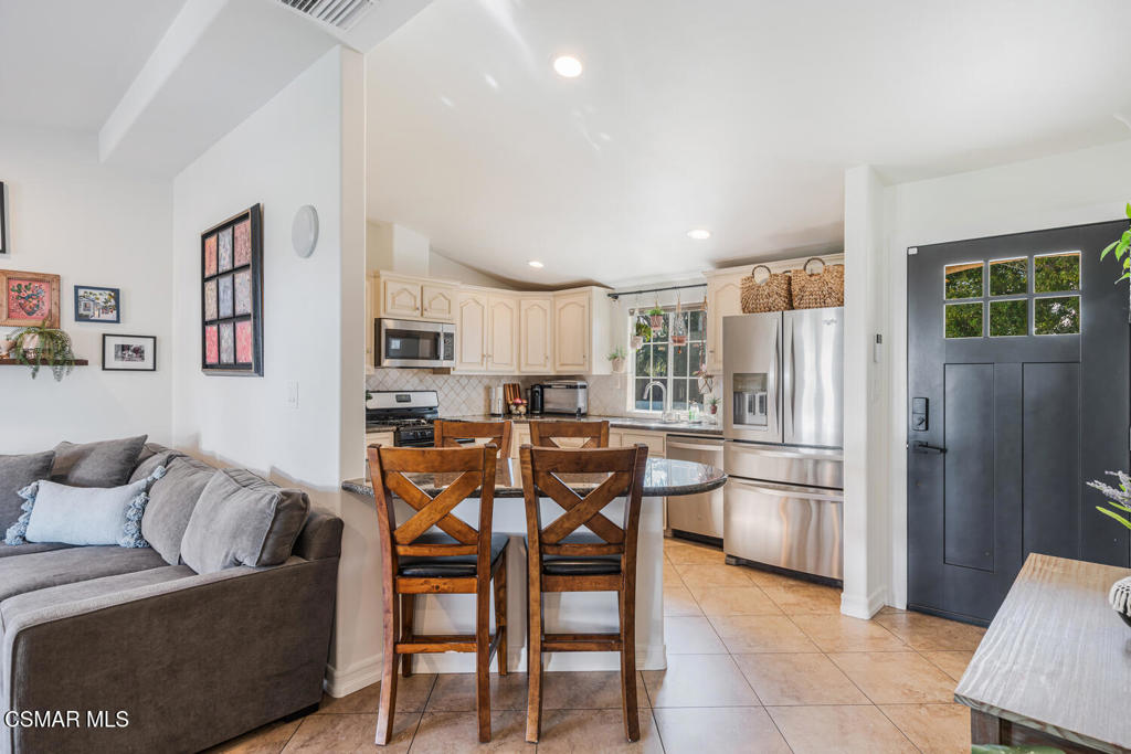 807 Briarcliff Road Thousand Oaks, CA 91360 - Photo 9 of 28 a living room with furniture a refrigerator and kitchen view