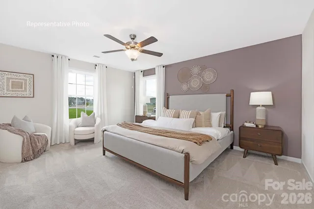 a bedroom with a bed couch and window