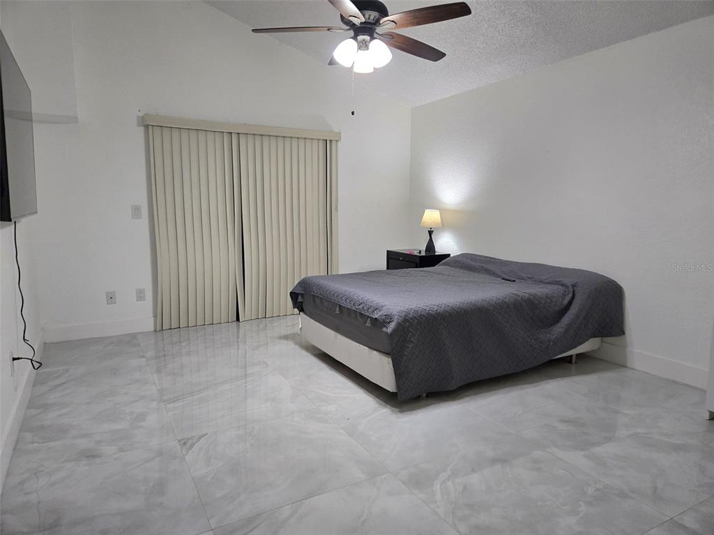2280 Springwood Circle West Clearwater, FL 33763 - Photo 12 of 25 a spacious bedroom with a bed and window