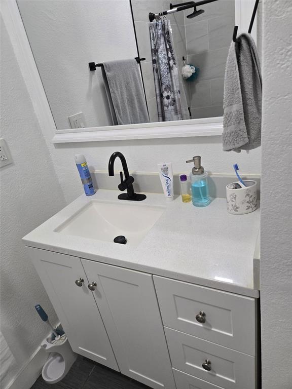 2280 Springwood Circle West Clearwater, FL 33763 - Photo 14 of 25 a bathroom with a sink and a mirror
