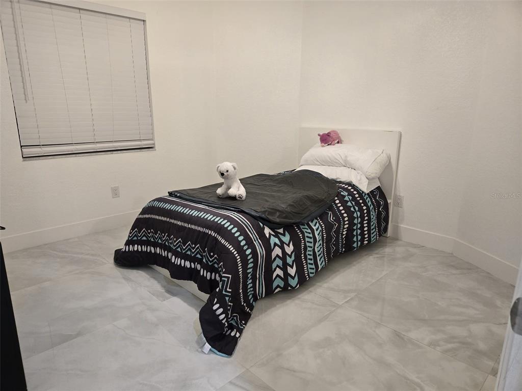 2280 Springwood Circle West Clearwater, FL 33763 - Photo 17 of 25 a bedroom with a bed and window