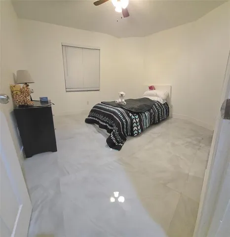 a bedroom with a bed and a lamp