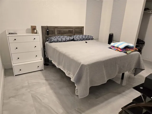 a bedroom with a bed and a desk