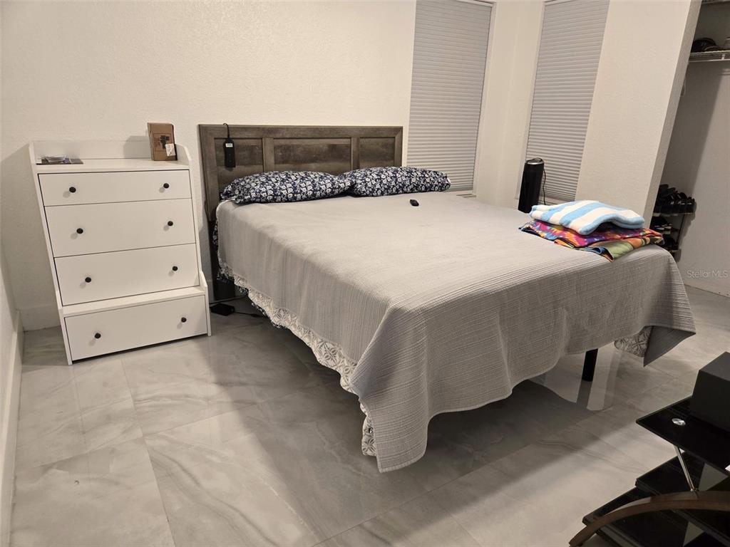 2280 Springwood Circle West Clearwater, FL 33763 - Photo 22 of 25 a bedroom with a bed and a desk