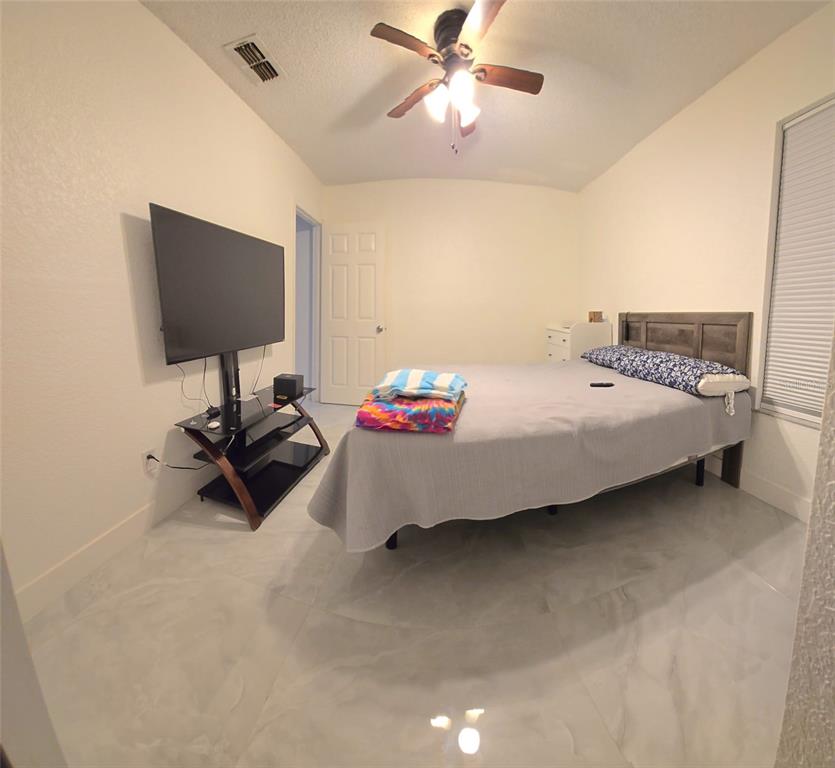 2280 Springwood Circle West Clearwater, FL 33763 - Photo 24 of 25 a bedroom with a bed and a flat screen tv
