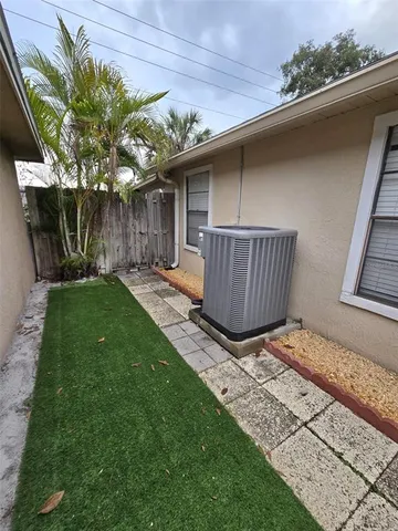 a backyard of a house with table and chairs