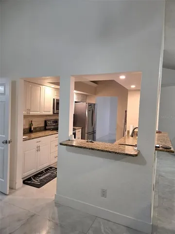 a kitchen with stainless steel appliances granite countertop a sink and cabinets