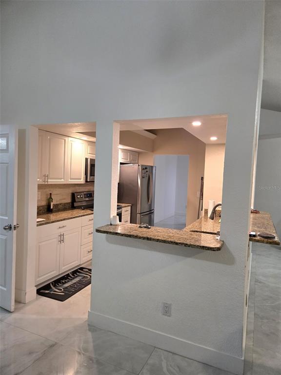 2280 Springwood Circle West Clearwater, FL 33763 - Photo 9 of 25 a kitchen with stainless steel appliances granite countertop a sink and cabinets