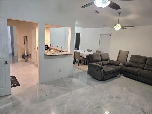 a living room with furniture and a chandelier