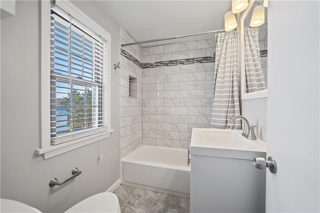 1006 Greenhill Road Pittsburgh, PA 15209 - Photo 11 of 24 a bathroom with a shower curtain and a sink