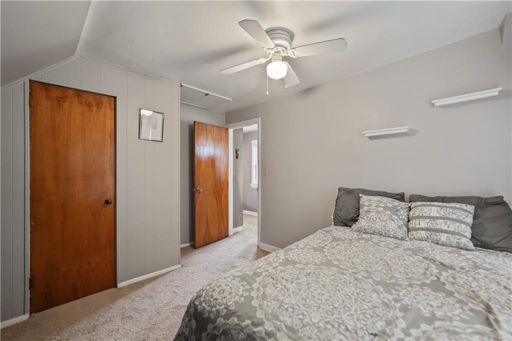 1006 Greenhill Road Pittsburgh, PA 15209 - Photo 15 of 24 a bedroom with a large bed and a chandelier