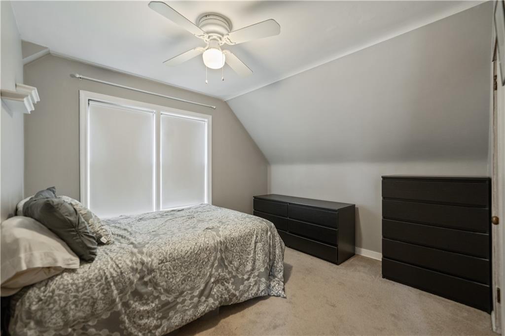1006 Greenhill Road Pittsburgh, PA 15209 - Photo 16 of 24 a bedroom with a bed and a chandelier