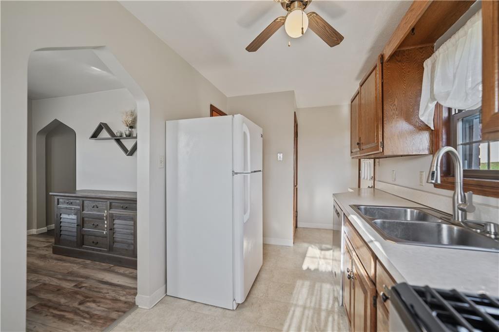 1006 Greenhill Road Pittsburgh, PA 15209 - Photo 10 of 24 a kitchen with stainless steel appliances granite countertop a refrigerator and a sink