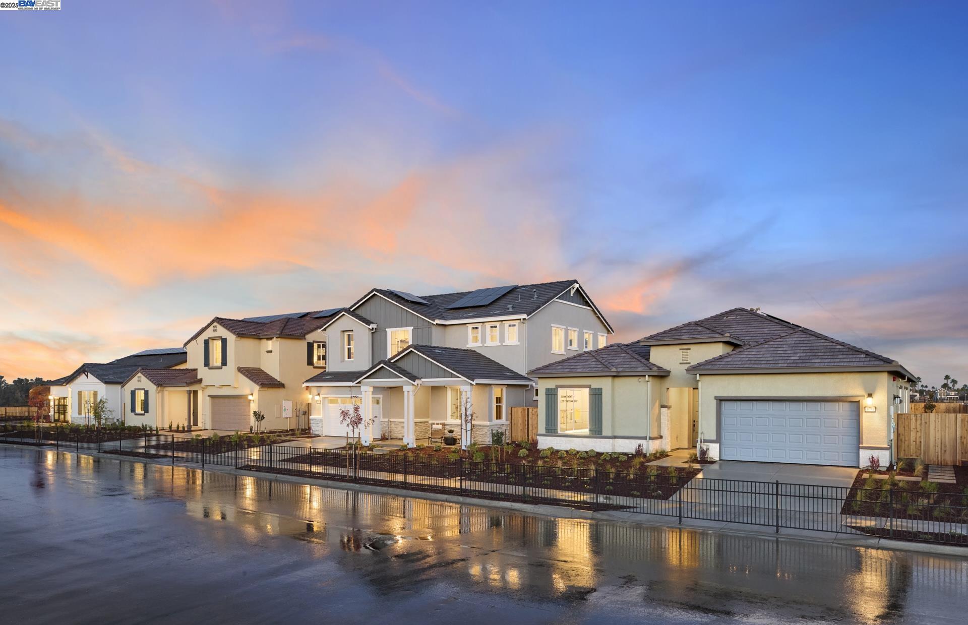 a view of a big house with a big yard plants and large trees